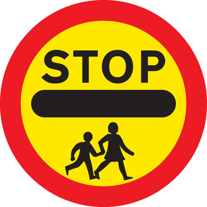 School crossing patrol ahead (some signs have amber lights which flash when crossings are in use)
