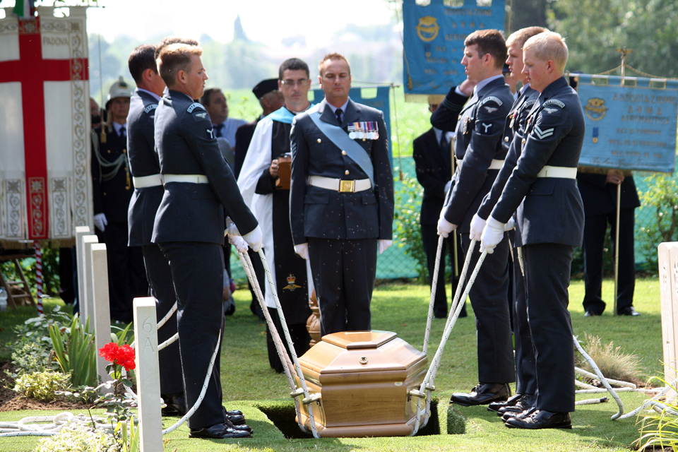 Members of the Queen's Colour Squadron lower the single coffin into the grave [Picture: Mike Drewett, Crown copyright]