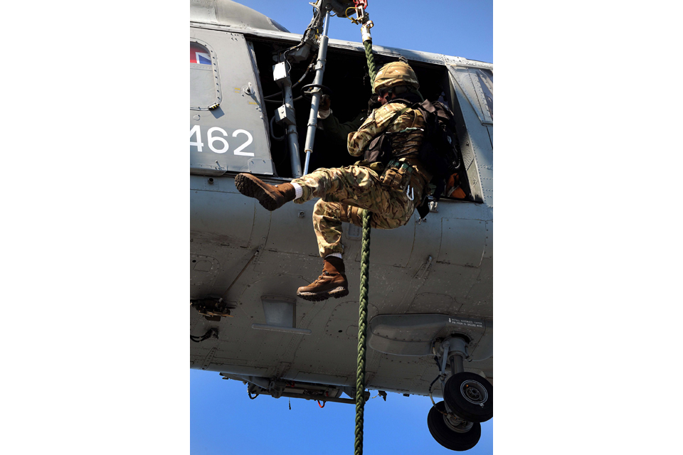 A Royal Marine fast ropes from a Lynx helicopter