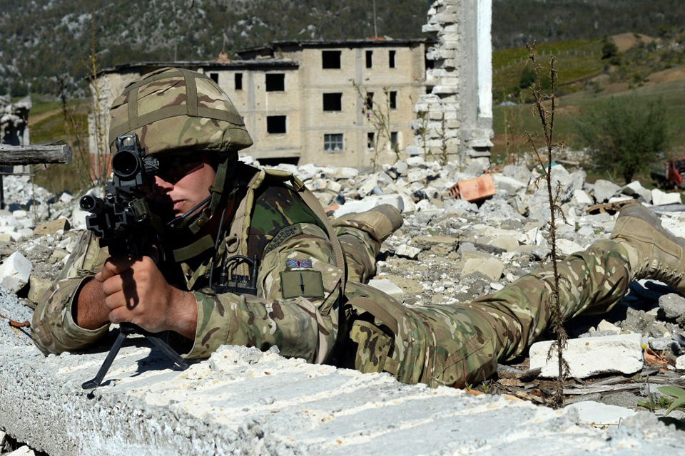 A Royal Marine looks through his rifle scope