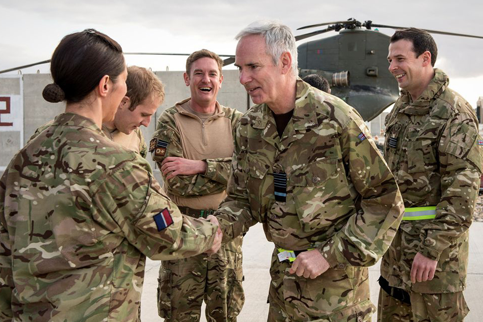Air Chief Marshal Sir Andrew Pulford greets a soldier at Camp Bastion
