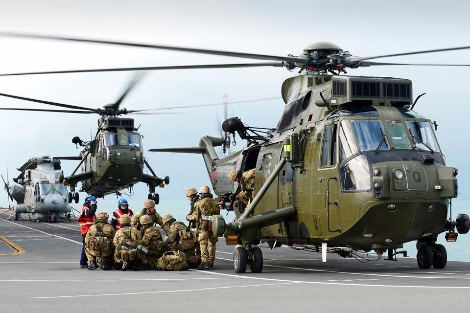 Royal Marines board a Sea King helicopter 