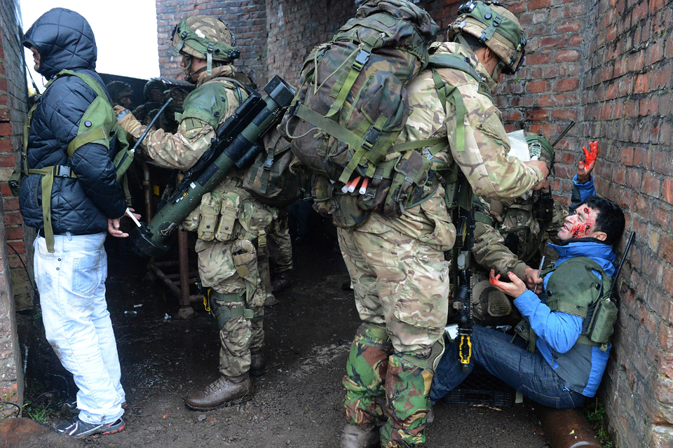 Royal Marines treating a civilian casualty 