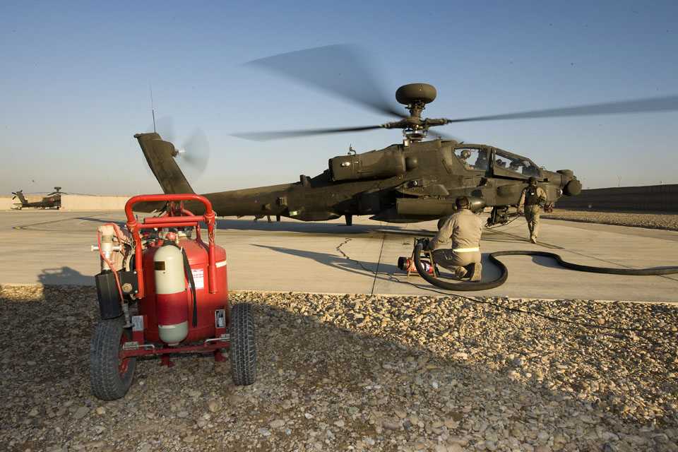 Ground crew prepare to refuel an Apache helicopter