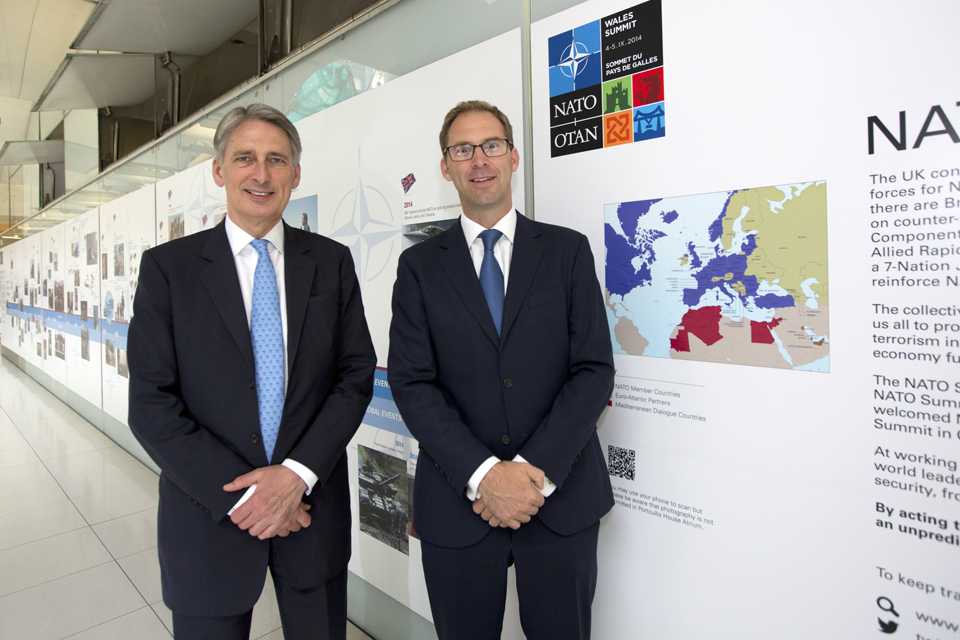 Philip Hammond (left) at the NATO 65-year timeline photographic display at Portcullis House