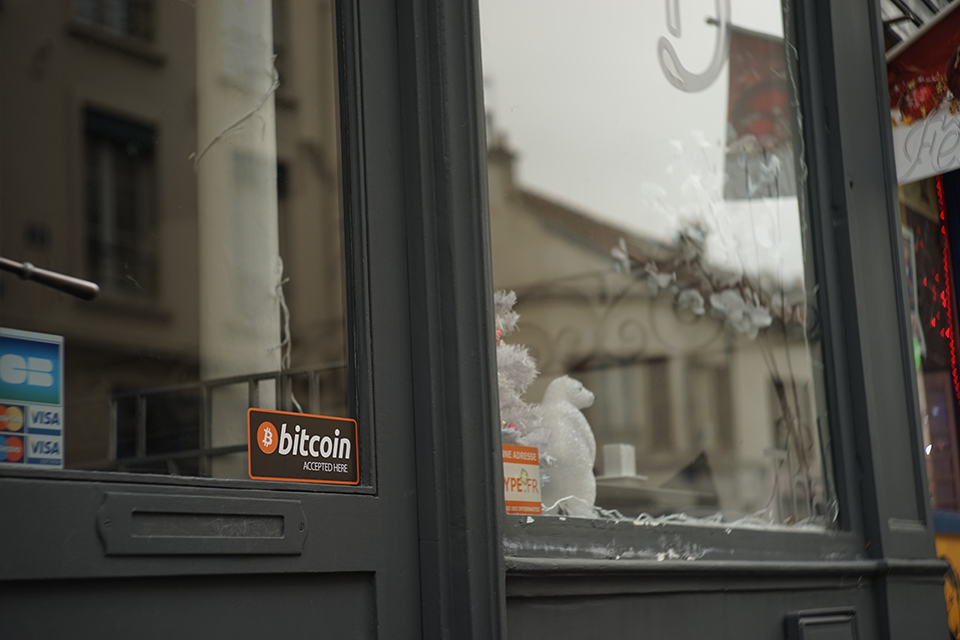 'Bitcoin accepted here' sign in a window