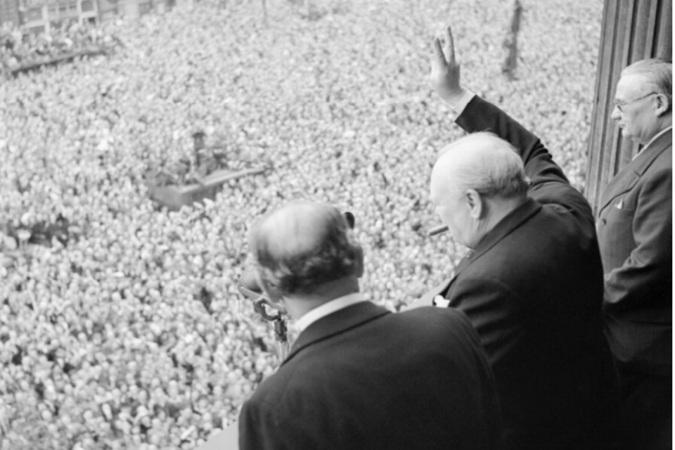 Winston Churchill waves to VE crowds