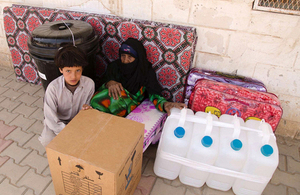 A Yemeni woman and child with an aid kit distributed by Save the Children. Picture: Save the Children/M. Awadh