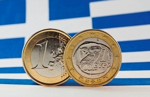Image of the Greek flag and euro coins