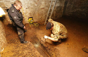 Military EOD experts examine an unexploded World War Two bomb in Bethnal Green