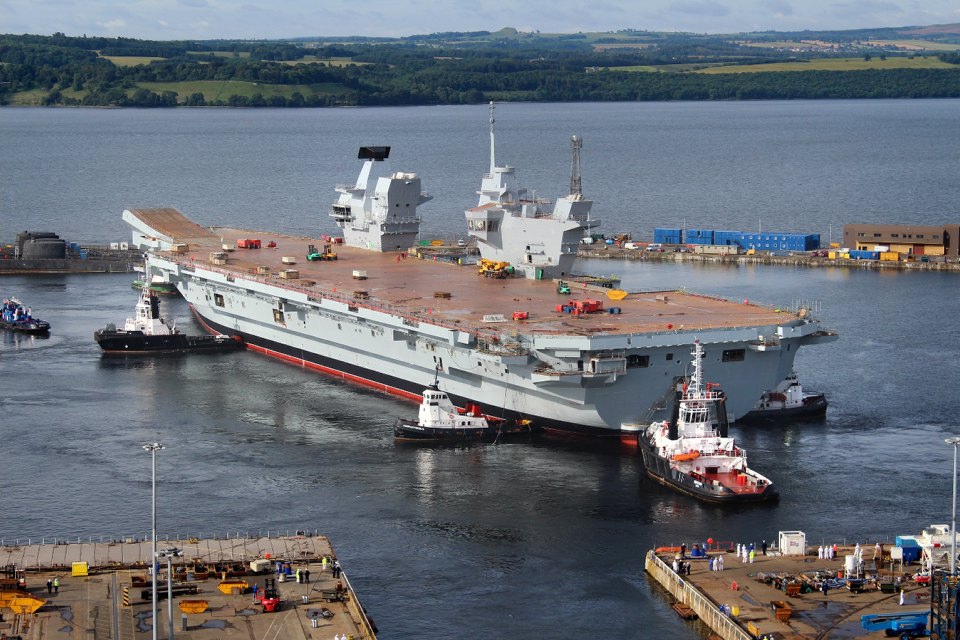 The Royal Navy's largest ever warship HMS Queen Elizabeth is gently floated out of her dock for the first time in Rosyth, Scotland in July 2014.