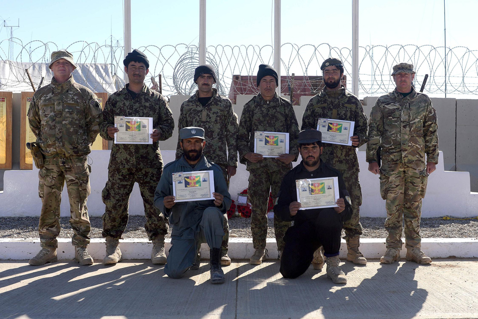 Newly-qualified Afghan explosives experts with their certificates and mentors