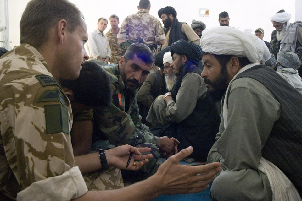 A Royal Marines Major talks to an Afghan village elder
